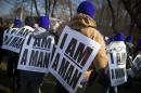 Demonstrators wearing "I AM A MAN" signs protest outside LaGuardia Airport during a protest march in New York