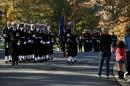 Honor guards from each military branch make their way through Arlington National Cemetery on Veteran's Day, November 11, 2012, in Arlington, Virginia