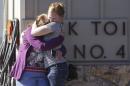 College alumnus is embraced after a mass shooting at Umpqua Community College in Roseburg