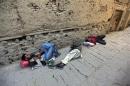 Homeless men sleep on the roadside in the old part of Kabul