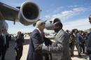 South Sudanese Foreign Minister Barnaba Marial Benjamin, right, welcomes US Secretary of State John Kerry upon his arrival at Juba International Airport, South Sudan, Friday May 2, 2014. Kerry, landing in the capital Juba on Friday, carried the threat of U.S. sanctions against prominent South Sudanese leaders if the rampant violence doesn't stop. But more than anything, he sought to compel authorities on both sides of the fight to put aside personal and tribal animosities for the good of a nation that declared independence three years ago to escape decades of war. (AP Photo/Saul Loeb, Pool)