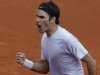 Switzerland's Roger Federer clenches his fist  after scoring against France's Gilles Simon in their fourth round match at the French Open tennis tournament, at Roland Garros stadium in Paris, Sunday June 2, 2013. (AP Photo/Christophe Ena)