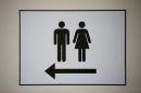 A sign points at the bathrooms