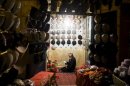 A Muslim man prays in his hat shop in Xinjiang, China