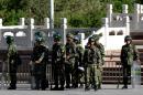 Paramilitary policemen stand guard on a city square in Urumqi in China's Xinjiang region on May 24, 2014
