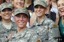 U.S. Army First Lt. Shaye Haver, center, and Capt. Kristen Griest, right, pose for photos with other female West Point alumni after an Army Ranger school graduation ceremony, Friday, Aug. 21, 2015, at Fort Benning, Ga. Haver and Griest became the first female graduates of the Army's rigorous Ranger School, putting a spotlight on the debate over women in combat. (AP Photo/John Bazemore)