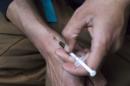 A man injects himself with heroin using a needle obtained from the People's Harm Reduction Alliance in Seattle, Washington