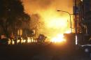 Flames from an explosion from an underground gas leak in the streets of Kaohsiung, Taiwan, early Friday, Aug. 1, 2014. A massive gas leakage early Friday caused five explosions that killed several people and injured over 200 in the southern Taiwan port city of Kaohsiung. (AP Photo) TAIWAN OUT