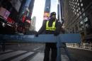 A security guard stands in Times Square as streets are closed in preparation for New Year's Eve celebrations in New York