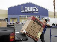 A contractor loads a bathroom vanity cabinet onto his truck after purchasing it at a Lowe's store in Burbank, California August 17, 2009. REUTERS/Fred Prouser