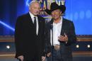 Jerry Jones, left, and George Strait speak on stage at the 49th annual Academy of Country Music Awards at the MGM Grand Garden Arena on Sunday, April 6, 2014, in Las Vegas. (Photo by Chris Pizzello/Invision/AP)