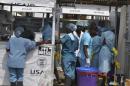 Health workers enter an Ebola treatment center in Monrovia