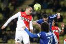 Monaco's Dimitar Berbatov, left, challenges for the ball with Bastia's Francois Modesto, down and BFlorian Marange during their French League One soccer match, in Monaco stadium, Friday, March 13, 2015. (AP Photo/Lionel Cironneau)