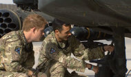 In this image from video, Britain's Prince Harry, left, has a close look at an Apache helicopter, during a tour with a member of his squadron, (name not provided) at Camp Bastion in Afghanistan, Friday Sept. 7, 2012. Prince Harry will be based at Camp Bastion during his tour of duty as a co-pilot gunner, returning to Afghanistan to fly attack helicopters in the fight against the Taliban. (AP Photo/TV Pool)
