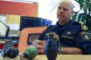 Mansson, head of Malmo's bomb squad, displays unexploded grenades found this year in the city
