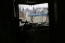 A sniper from the Iraqi rapid response forces takes up position at a hospital damaged by clashes during a battle between Iraqi forces and Islamic State militants in the Wahda district of eastern Mosul