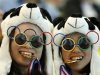 Two Chinese fans pause for photos prior to the Women's Synchronized 10 Meter Platform Diving final at the Aquatics Centre in the Olympic Park during the 2012 Summer Olympics, London, Tuesday, July 31, 2012. (AP Photo/Jae C. Hong)