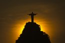 FILE - In this Friday, Dec. 28, 2012 file photo, the sun sets behind the Christ the Redeemer statue and the Corcovado mountain in Rio de Janeiro, Brazil, two days after the city recorded its hottest day since 1915 at 43 degrees Celsius (109.7 degrees Fahrenheit). New weather data shows that the world's average temperature in 2012 barely slipped into the top 10 hottest years on record, despite the U.S. smashing heat marks. The National Oceanic and Atmospheric Administration says last year's world average temperature was 58 degrees Fahrenheit (14.5 degrees Celsius) - a full degree above the 20th century average of 57 F (13.9 C). NASA, which measures temperatures differently, ranks 2012 as ninth warmest. Both agencies announced the data Tuesday, Jan. 15, 2013. (AP Photo/Felipe Dana)