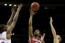 Stanford's Chasson Randle (5) gets between Kansas's Andrew Wiggins, left, Conner Frankamp (23) and k23=, right, to shoot during the first half of a third-round game at the NCAA college basketball tournament Sunday, March 23, 2014, in St. Louis. (AP Photo/Charlie Riedel)