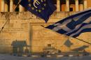 Pro-Euro demonstrators wave a Greek flag, right, and a European Union flag in front of the Tomb of the Unknown Soldier during a rally at Syntagma square in Athens, Thursday, July 9, 2015. Hopes that Greece can get a rescue deal that will prevent a catastrophic exit from the euro rose on Thursday, after key creditors said they were open to discussing how to ease the country's debt load, a long-time sticking point in their talks. (AP Photo/Petros Karadjias)