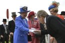 Britain's Queen Elizabeth shakes hands with a racegoer as she arrives with Prince Philip at the Epsom Derby festival in Epsom