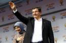 Turkish Prime Minister Ahmet Davutoglu greets his supporters during an election rally of his AK Party in Ankara