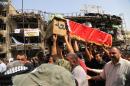 Mourners carry the Iraqi flag-draped coffin of, Akram Hadi, 24, in a Sunday massive truck bomb attack in the Karada neighborhood of Baghdad, Iraq, Tuesday, July 5, 2016. Iraqi officials say that more dead bodies have been recovered from the site of the weekend suicide bombing in central Baghdad, bringing the death toll to over 170. The staggering figure is announced as Iraqis mourn and prepare for the Muslim holiday of Eid al-Fitr under the pall of one the worst bombings in 13 years of war. An Islamic State suicide bomber struck Baghdad's bustling commercial area of Karada early on Sunday when many residents were out before the start of the dawn fast. (AP Photo/Karim Kadim)