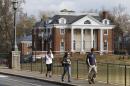 FILE - In this Monday, Nov. 24, 2014, file photo, University of Virginia students walk to campus past the Phi Kappa Psi fraternity house at the University of Virginia in Charlottesville, Va. Rolling Stone is casting doubt on the account it published of a young woman who says she was gang-raped at a Phi Kappa Psi fraternity party at the school, saying there now appear to be discrepancies in the student's account. (AP Photo/Steve Helber, File)