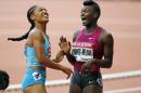 Dawn Harper Nelson of the U.S. , right, reacts after winning the 100m Hurdles Women's race ahead of Queen Harrison of the U.S. during the Athletics Diamond League meeting at Stade de France stadium, in Saint Denis, north of Paris, France, Saturday, July 5, 2014. (AP Photo/Francois Mori)