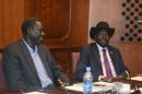 South Sudan's President Salva Kiir sits with South Sudan's Cabinet Affairs Minister Deng Alor at the meeting table at the Sheraton hotel in Addis Ababa