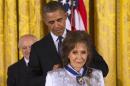 President Barack Obama awards country music legend Loretta Lynn with the Presidential Medal of Freedom, Wednesday, Nov. 20, 2013, during a ceremony in the East Room of the White House in Washington. (AP Photo/Jacquelyn Martin)