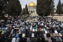 Palestinian worshippers take part in Friday prayers outside the Dome of the Rock at the Al-Aqsa mosque compound in the Old City of Jerusalem on November 14, 2014