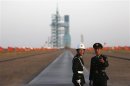 File photo of soldiers standing in front of the Long March II-F rocket at the Jiuquan Satellite Launch Center