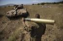 An Israeli soldier carries a tank shell near Alonei Habashan on the Israeli occupied Golan Heights