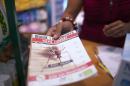 A shopkeeper hands a customer documentation about the mosquito-born chikungunya virus at a drugstore in Lamentin, on the French Caribbean island of La Martinique on July 10, 2014