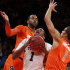 Temple's Khalif Wyatt (1) drives to the basket between Syracuse's James Southerland, left, and Michael Carter-Williams, right, during the first half of an NCAA college basketball game in the Gotham Classic at Madison Square Garden, Saturday, Dec. 22, 2012, in New York. (AP Photo/Jason Decrow)