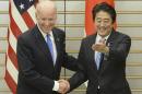 U.S. Vice President Joe Biden, left, is welcomed by Japanese Prime Minister Shinzo Abe prior to their talks at Abe's official residence in Tokyo Tuesday, Dec. 3, 2013. Biden, who is on the first leg of his three-nation Asian tour, met Abe, whose government is pressing the U.S. to more actively take Japan's side in an escalating dispute over China's new air defense zone above a set of contested islands in the East China Sea. (AP Photo/Toru Yamanaka, Pool)