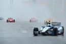 Helio Castroneves of Brazil leads a pack of cars during parade laps of race 1 of the Verizon IndyCar Series Honda Indy Toronto on the streets of Toronto on July 19, 2014