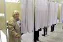 Woman leaves a ballot booth after casting her vote during general elections in Vilnius