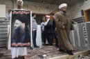 A pro-Sheikh Ahmed al-Assir demonstrator stands while Sheikh Mohammad Abou Zeid walks down the stairs outside of Bilal bin Rabah mosque complex in Abra near Sidon