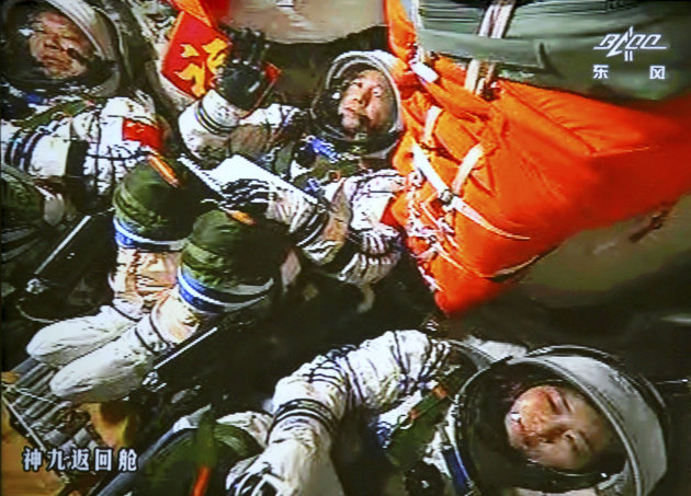 FILE - In this June 16, 2012 file image made off the monitor screen at the Beijing Aerospace Flight Control Center and released by China's Xinhua News Agency, China's astronauts Jing Haipeng, center, Liu Wang, left, and Liu Yang sit inside the capsule after the launch of China's manned Shenzhou-9 spacecraft. China's astronauts have braved the tension of docking with a space station and performed delicate tasks outside their orbiting capsule, but now face a more down-to-Earth job that is perhaps equally challenging: Talking to young people about science. Coming on the heels of Canadian astronaut Chris Hadfield's wildly popular YouTube videos from the International Space Station, the three astronauts aboard China's latest mission, expected to launch early June 2013, plan to deliver a series of talks to students from aboard China's Tiangong 1 space lab.(AP Photo/Beijing Aerospace Flight Control Center via Xinhua, File) NO SALES