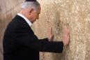 Israeli Prime Minister Benjamin Netanyahu prays at the Western Wall, the holiest site where Jews can pray, in Jerusalem's Old City, Saturday Feb. 28, 2015. (AP Photo/Marc Sellem, Pool)