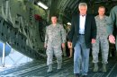 In this photo taken July 17, 2013, Defense Secretary Chuck Hagel, flanked by Air Force personnel, walks down the rear ramp of a C-17 at Joint Base Charleston near Charleston, S.C., on the last day of a three-day trip to visit bases in the Carolinas and Florida. When Hagel told civilian Department of Defense workers on the base that job furloughs, that have forced a 20% pay cut on most of the military's civilian workforce, will likely continue next year, and may get even worse, the audience softly gasped in surprise and gave a few depressed low whistles. He said that if the department has to absorb another $52 billion in cuts next year because of the federal sequester, there will likely be layoffs instead of furloughs. (AP Photo/Bruce Smith)