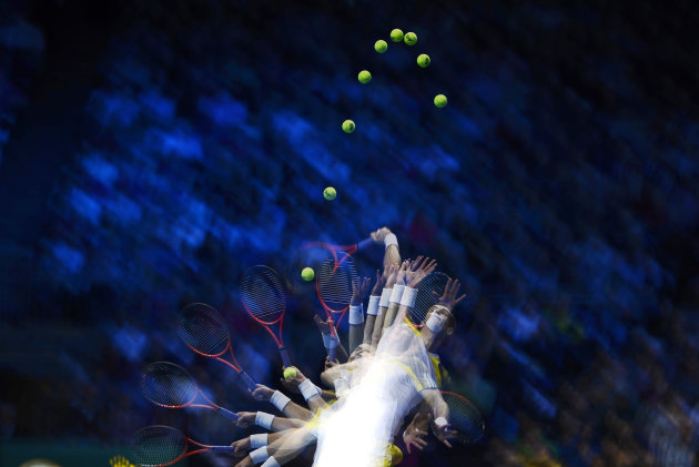A multiple exposure photograph shows Britain's Murray as he serves to Serbia's Djokovic during their men's singles tennis match at the ATP World Tour Finals in London