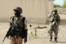 Nigerian soldiers patrol in the north of Borno state close to a Islamist extremist group Boko Haram former camp near Maiduguri on June 5, 2013