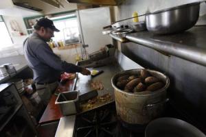 Syed Zunnoor cooks eggs and bacon as potatoes are boiled&nbsp;&hellip;