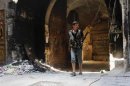 A young Free Syrian Army fighter is seen with his weapon in old Aleppo