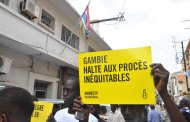 File picture shows protesters holding a banner reading 'Gambia. Stop unfair trials' outside the Gambian embassy in Senegal last year (AFP Photo/Seyllou)