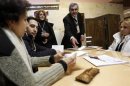 Election officials count ballots after polls closed at a polling station in Yerevan