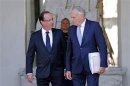 French President Hollande escorts France's Prime Minister Ayrault at the Elysee Palace in Paris after the government seminar